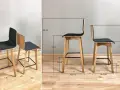 Dwa nowoczesne hokery z drewnianymi nogami i czarnym siedziskiem. Wymiary pokazują idealną wysokość hokera do blatu.