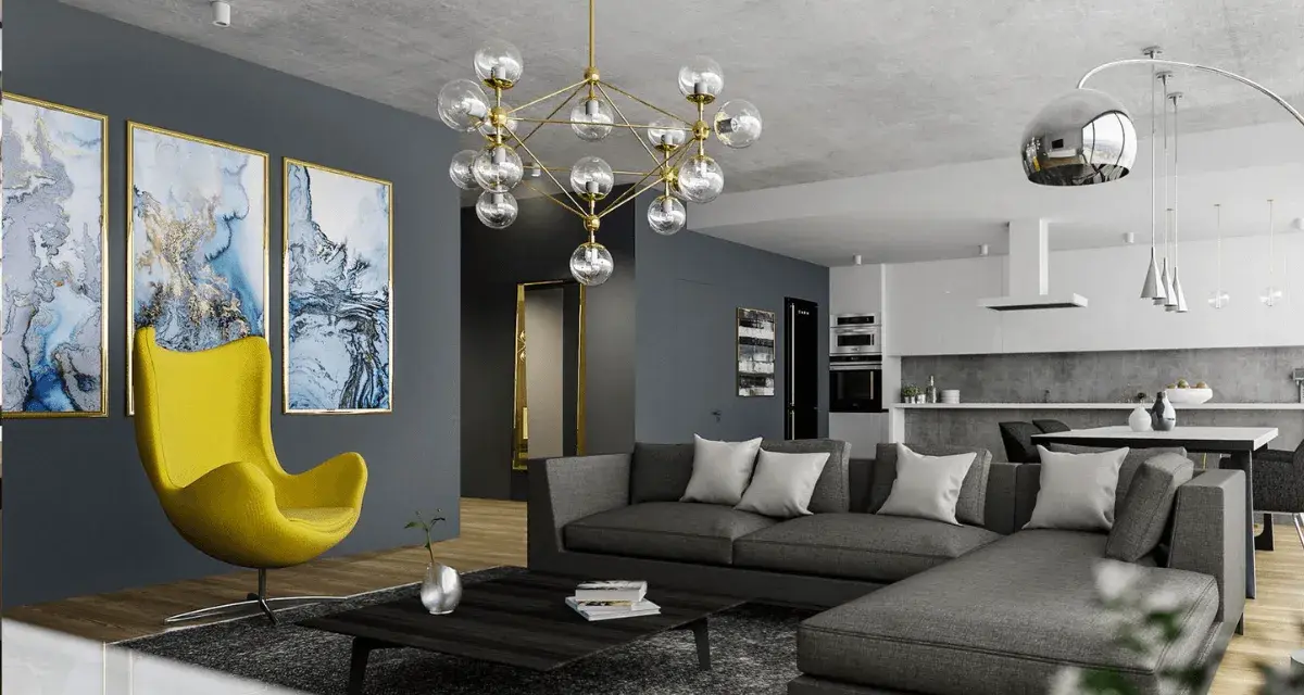 Nowoczesny salon z szarą kanapą i żółtym fotelem. Obrazy i designerska lampa dodają charakteru, pokazując, jak rozjaśnić pokój dodatkami.