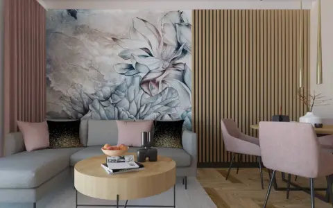 Elegancki salon z sofą i stolikiem kawowym w odcieniach brązu i pudrowego różu. Na ścianie duża, malarska tapeta z kwiatowym motywem.