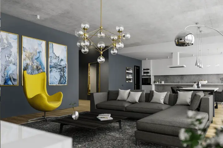Nowoczesny salon z szarą kanapą i żółtym fotelem. Obrazy i designerska lampa dodają charakteru, pokazując, jak rozjaśnić pokój dodatkami.