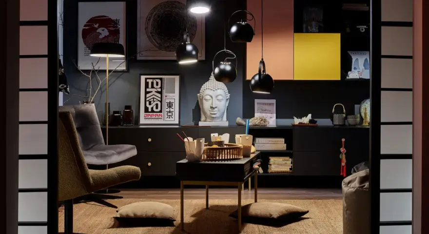 Salon w stylu eklektycznym z motywami azjatyckimi. Wygodne fotele, stolik z poduszkami, rzeźba Buddy i plakaty z Japonii tworzą przytulną atmosferę.